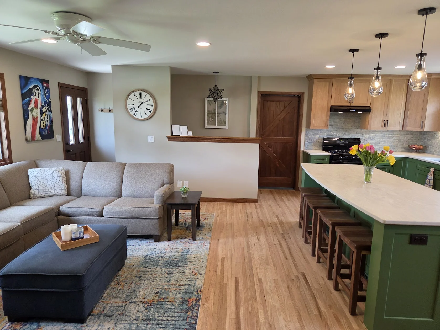 Connected living room and kitchen in a remodeled open main level.