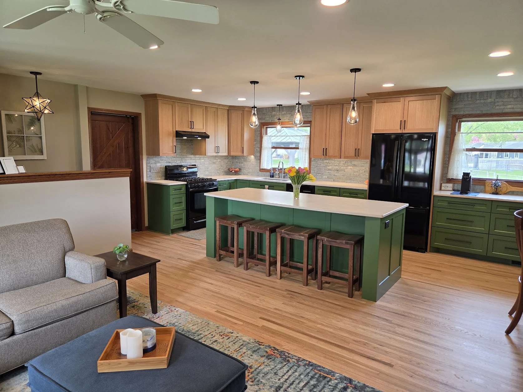 The completed open living room and green kitchen