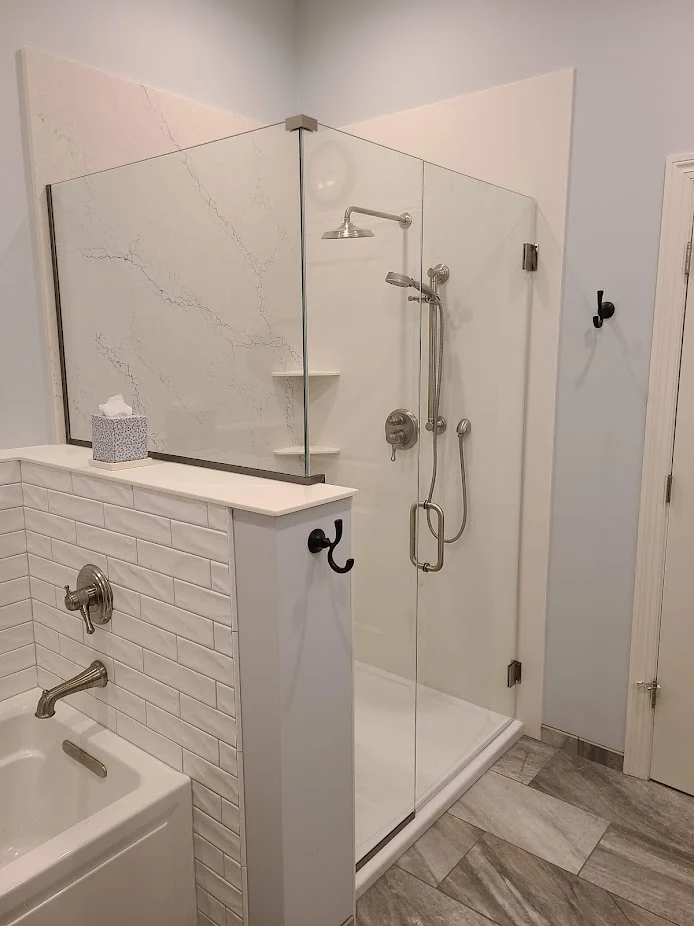 Custom glass shower beside a soaking tub in the Master Bath and Closet project