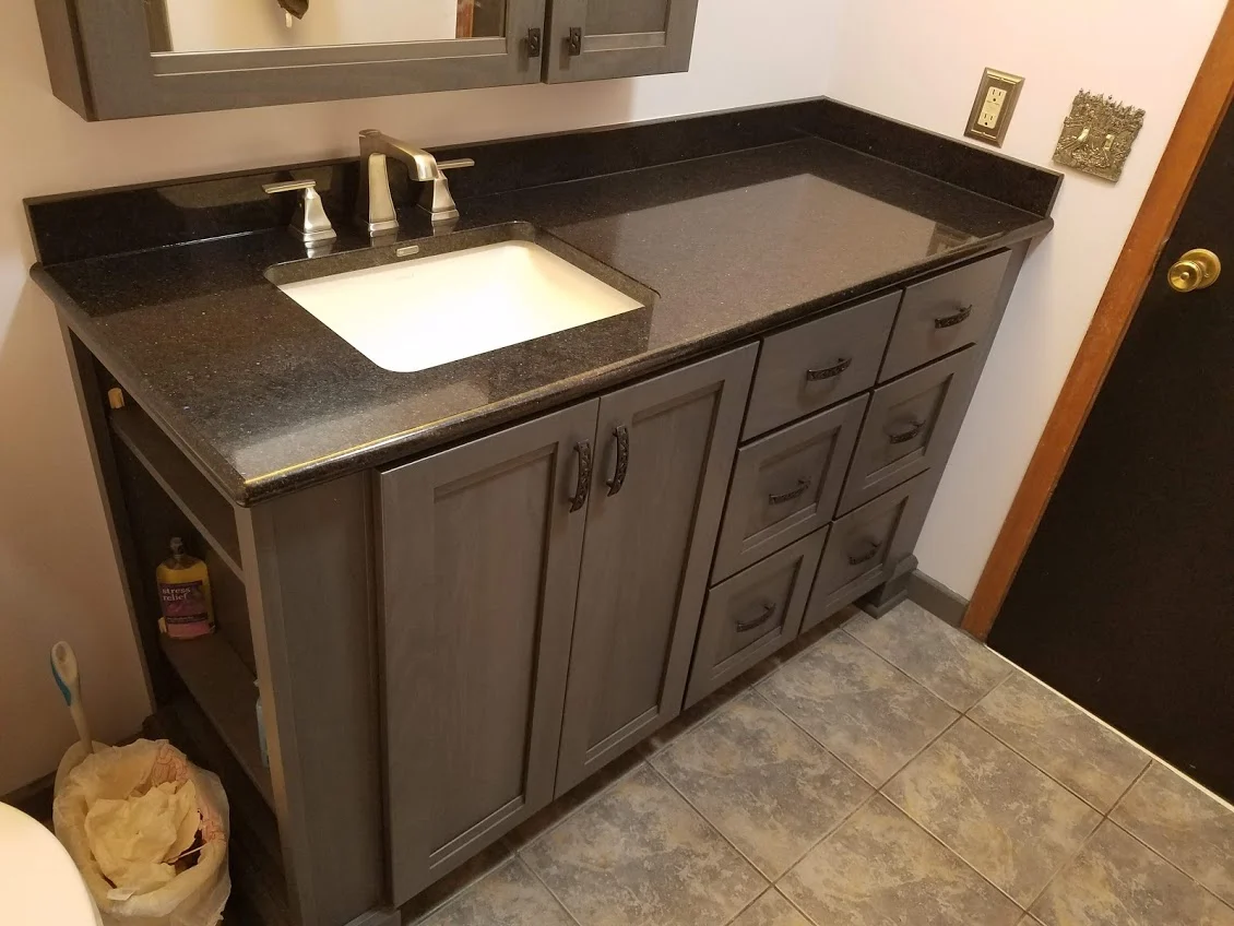 Gray cabinetry and coordinated finishes in a modern bathroom