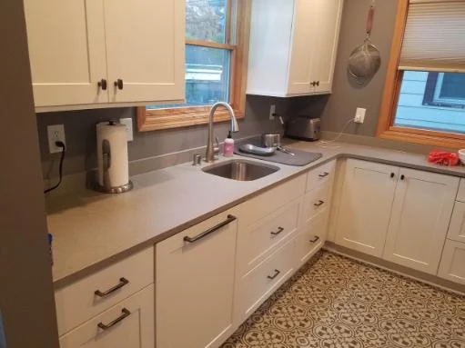 White cabinetry and quartz counters in the Tiny Minneapolis Kitchen